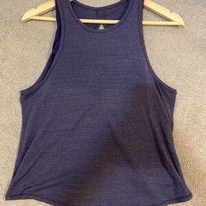 top has attached sports bra. Split in the back. Tiny hole in front